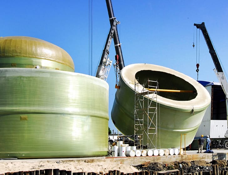 FRP Fiber glass plastic tank/vessel section being lifted by a crane for transportation